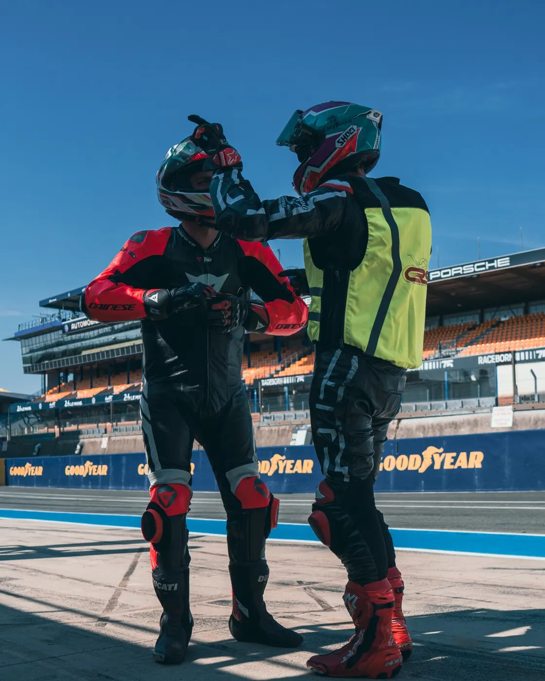A CRS coach talking a rider through the session in the pit lane