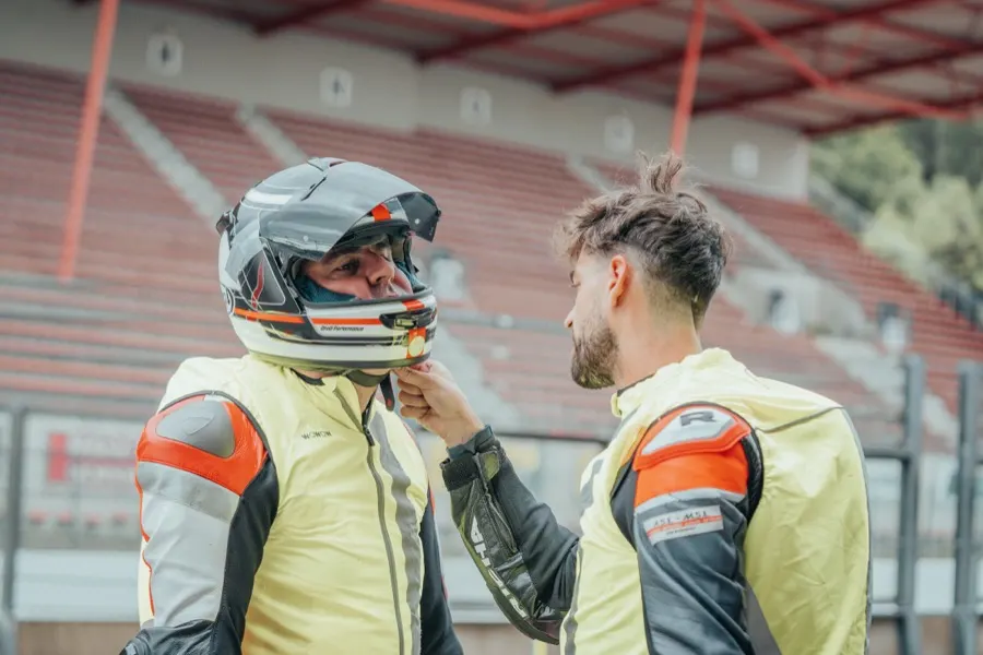 A CRS instructor checking a rider’s helmet before a session