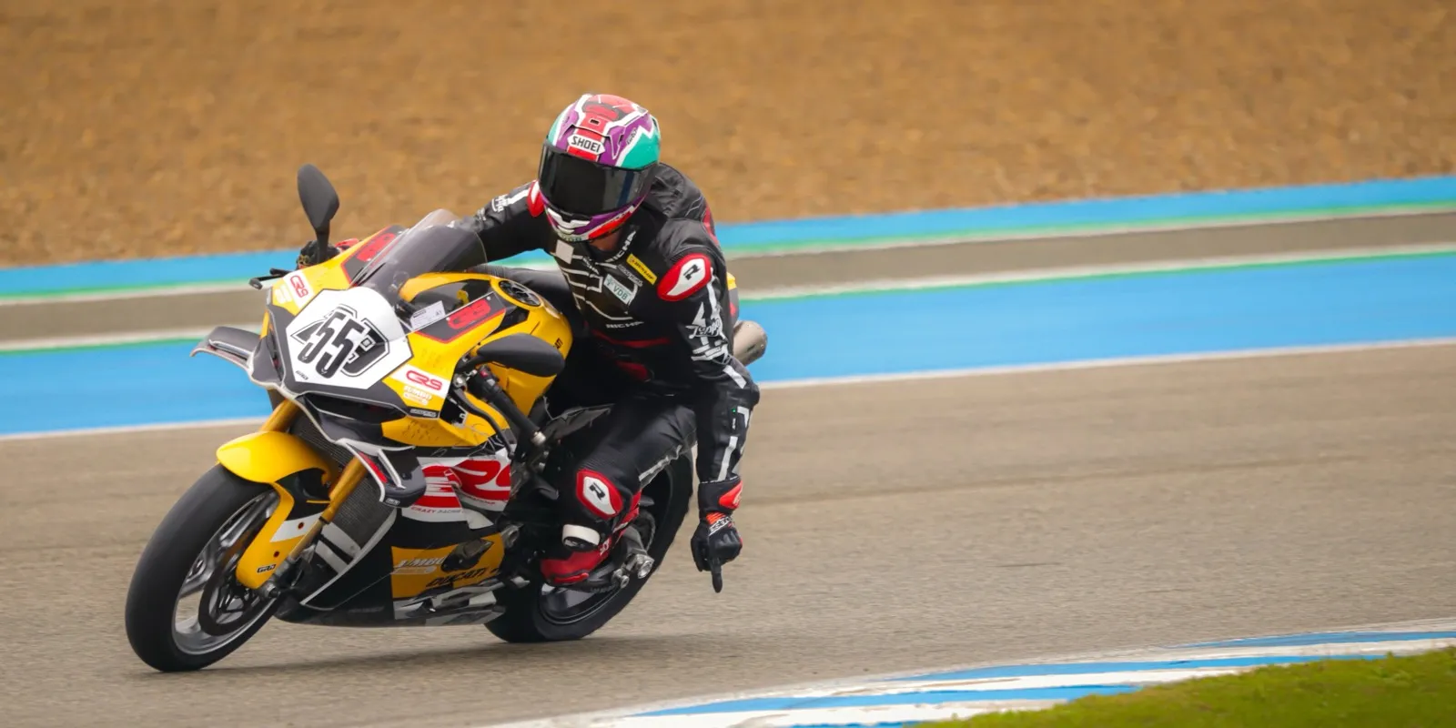 A rider at full lean through a corner on a CRS Ducati