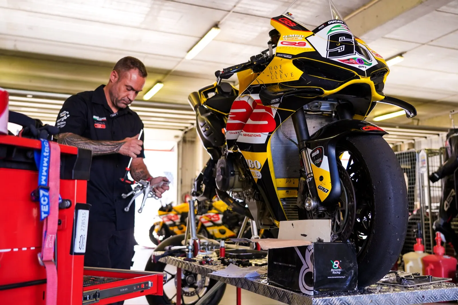A CRS mechanic working on a rider’s Ducati in the team box